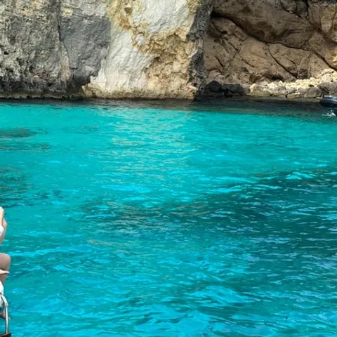 Clear blue water against the Comino cliffs