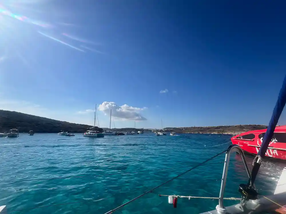Boats scattered across the channel under a wide blue sky