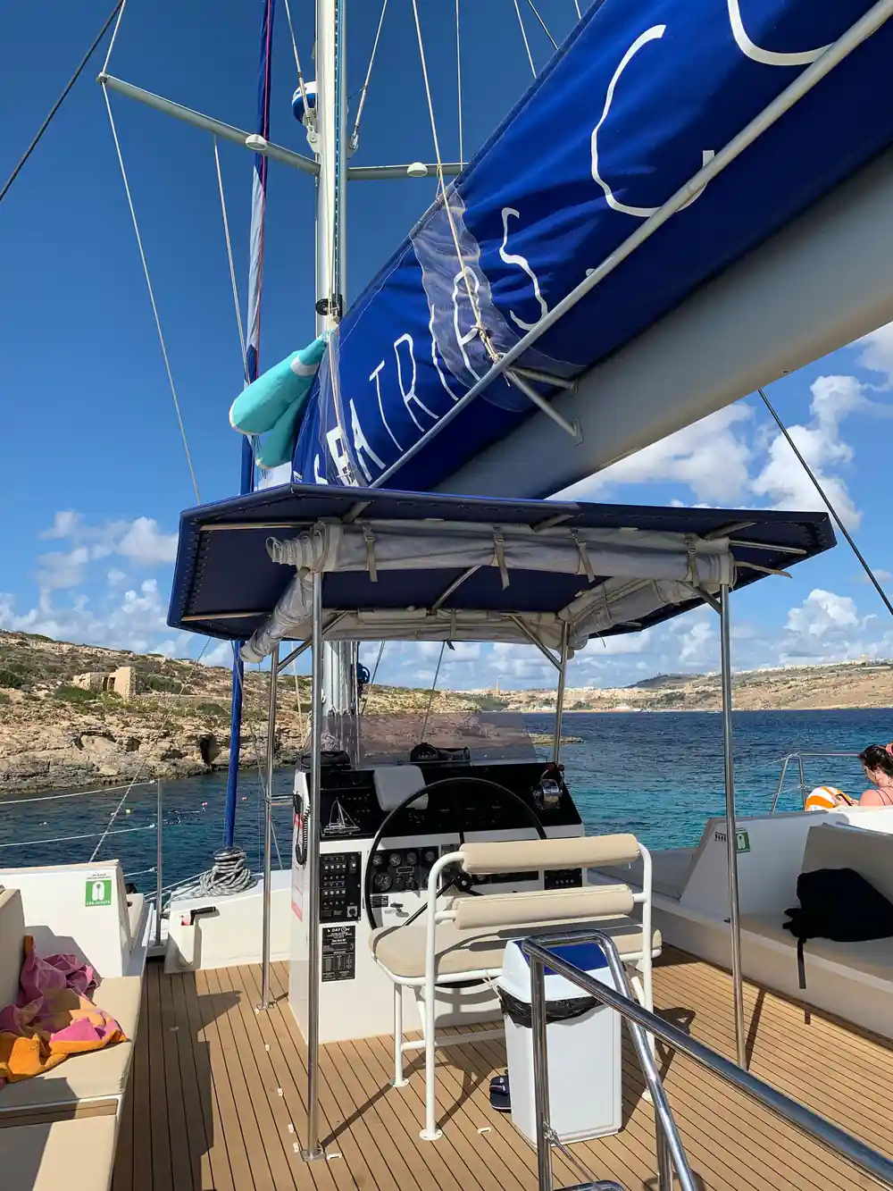 The helm station under its canopy with passengers behind