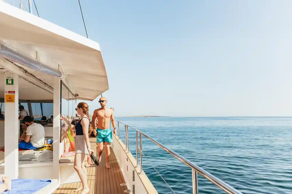 Passengers on the aft deck looking out at open sea
