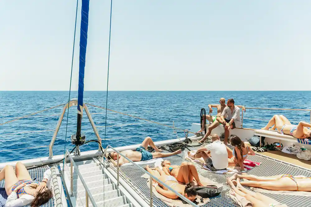Passengers stretched out on the netting and deck as the boat sails