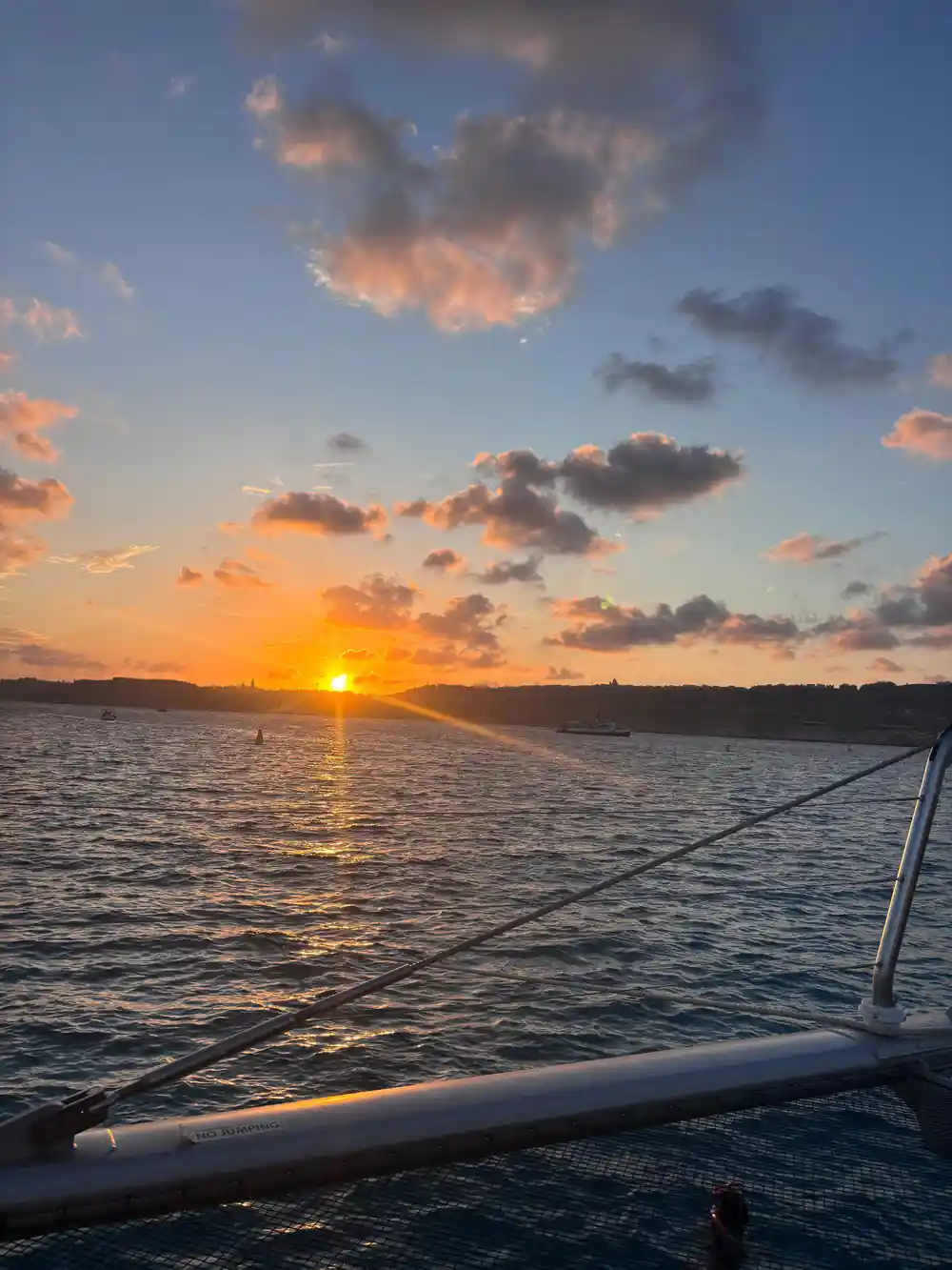 Sunset over open water with cloud lit from beneath