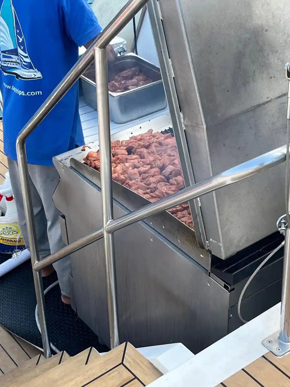 Trays of raw kebabs on the boat's grill before service