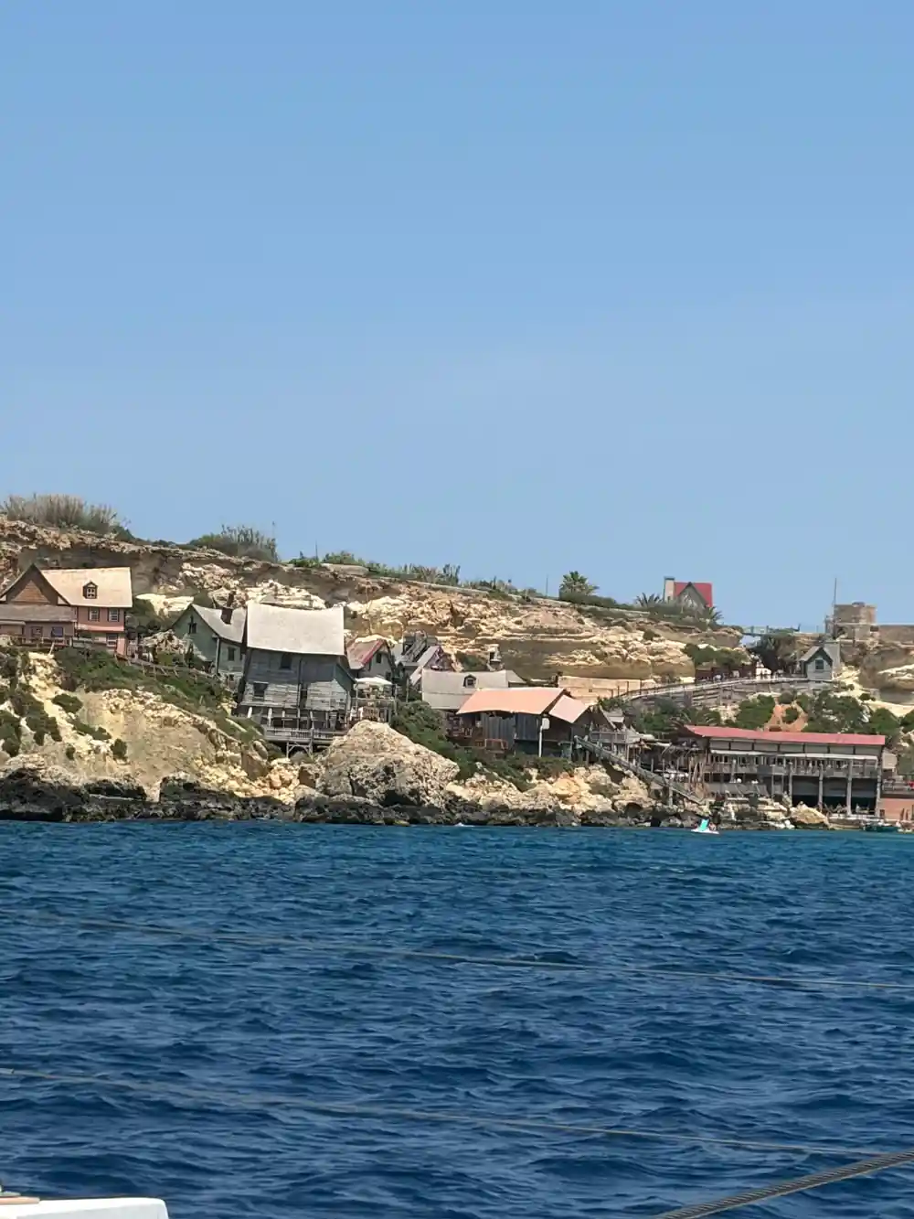 The village at Anchor Bay strung along the top of a low cliff