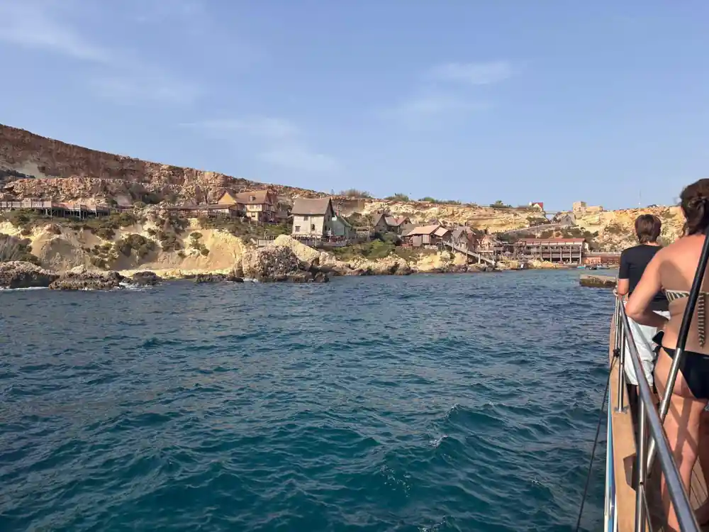 The wooden village at Anchor Bay seen across the water from the boat