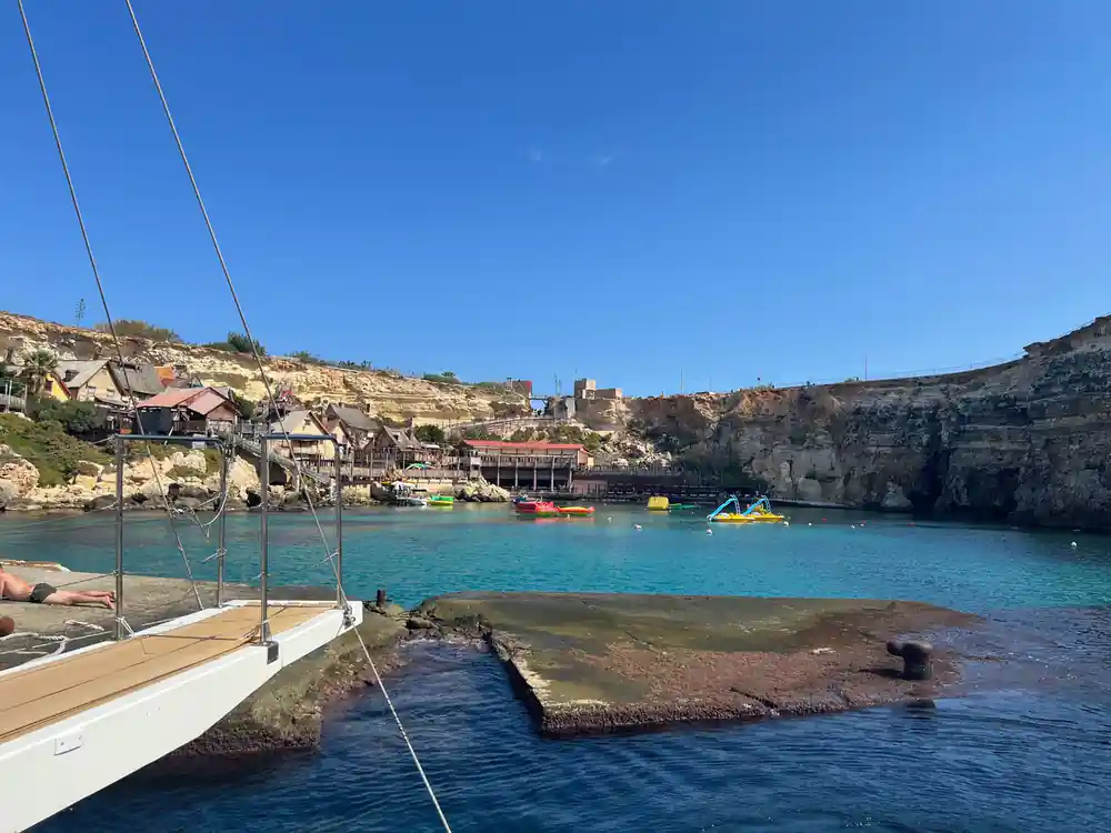 The wooden village and its small jetty seen across the inlet