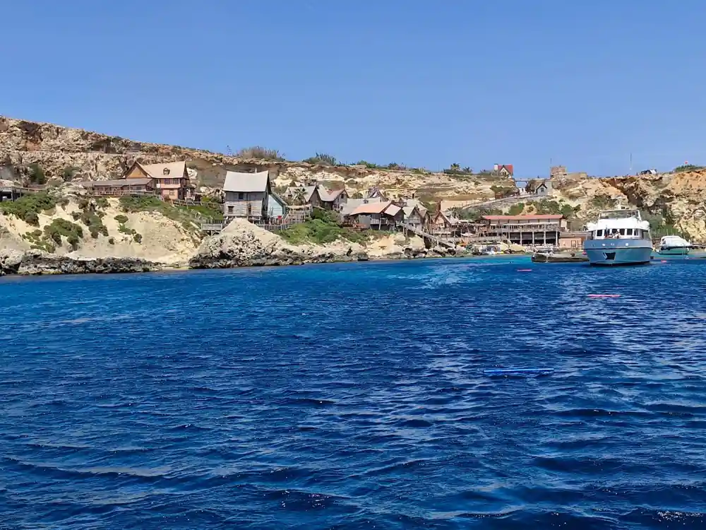 The wooden village above the water at Anchor Bay, red roofs among rock